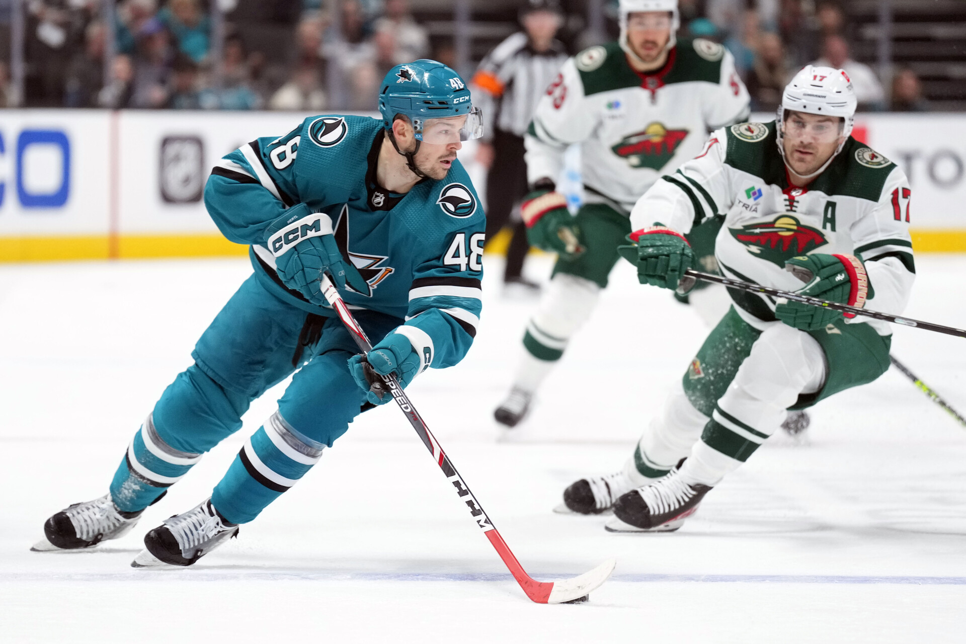 Mar 11, 2023; San Jose, California, USA; San Jose Sharks center Tomas Hertl (48) skates with the puck against Minnesota Wild left wing Marcus Foligno (17) during the second period at SAP Center at San Jose.