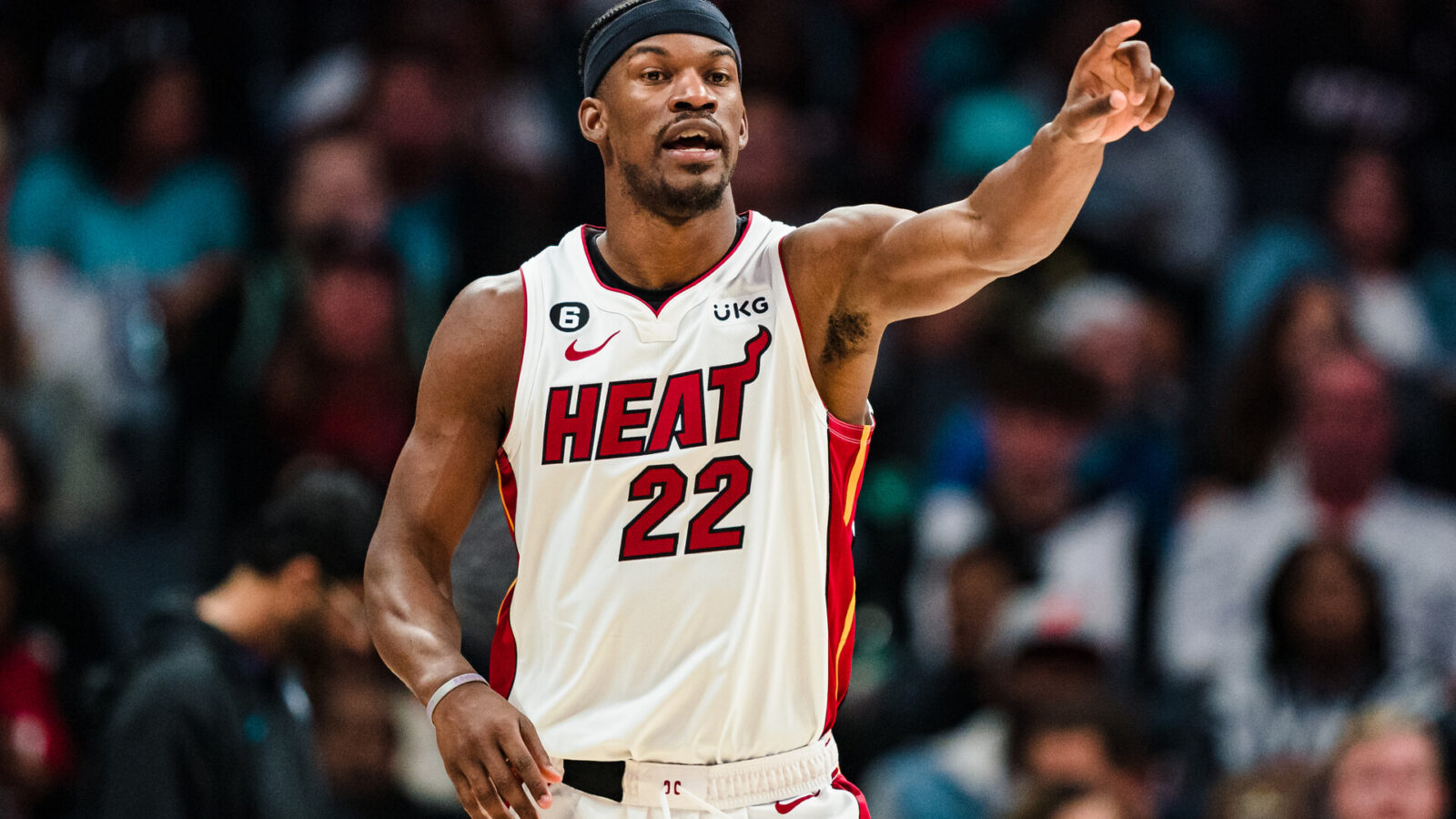 Jimmy Butler #22 of the Miami Heat directs a play against the Charlotte Hornets during their game at Spectrum Center on February 25, 2023 in Charlotte, North Carolina.