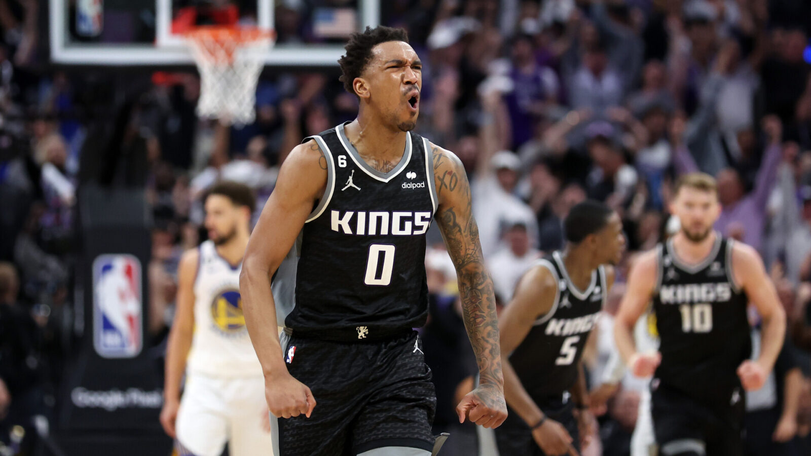 Malik Monk #0 of the Sacramento Kings reacts after De'Aaron Fox #5 of the Sacramento Kings made a three-point basket in the fourth quarter against the Golden State Warriors during Game Two of the Western Conference First Round Playoffs at Golden 1 Center on April 17, 2023 in Sacramento, California.