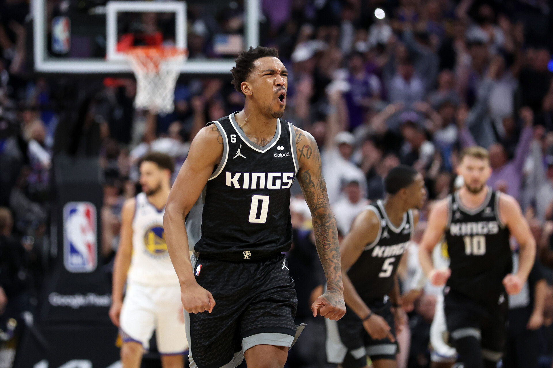 Malik Monk #0 of the Sacramento Kings reacts after De'Aaron Fox #5 of the Sacramento Kings made a three-point basket in the fourth quarter against the Golden State Warriors during Game Two of the Western Conference First Round Playoffs at Golden 1 Center on April 17, 2023 in Sacramento, California.