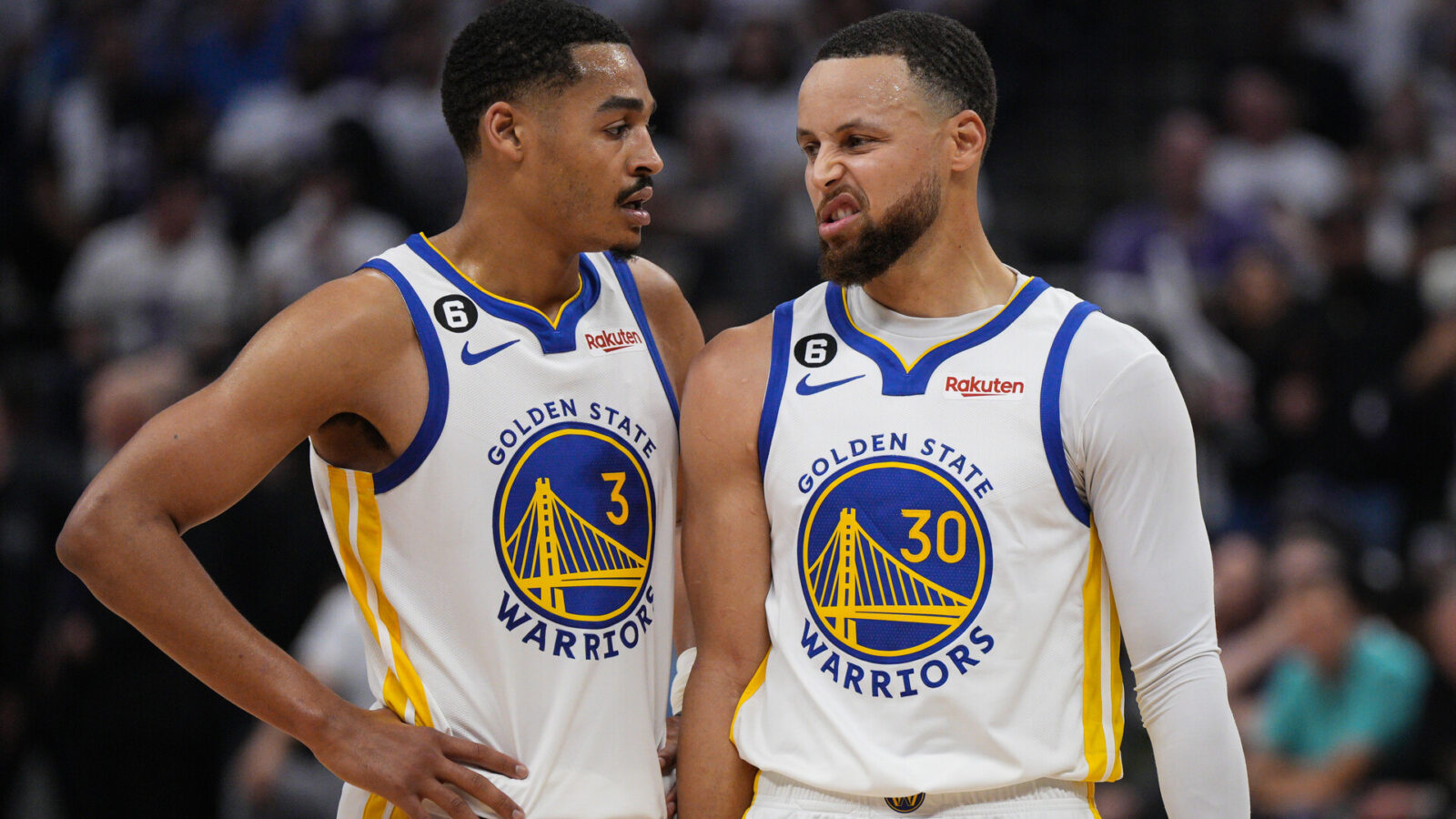 Jordan Poole #3 and Stephen Curry #30 of the Golden State Warriors talk during the second quarter of Game One of the Western Conference First Round Playoffs at the Golden 1 Center on April 15, 2023 in Sacramento, California.