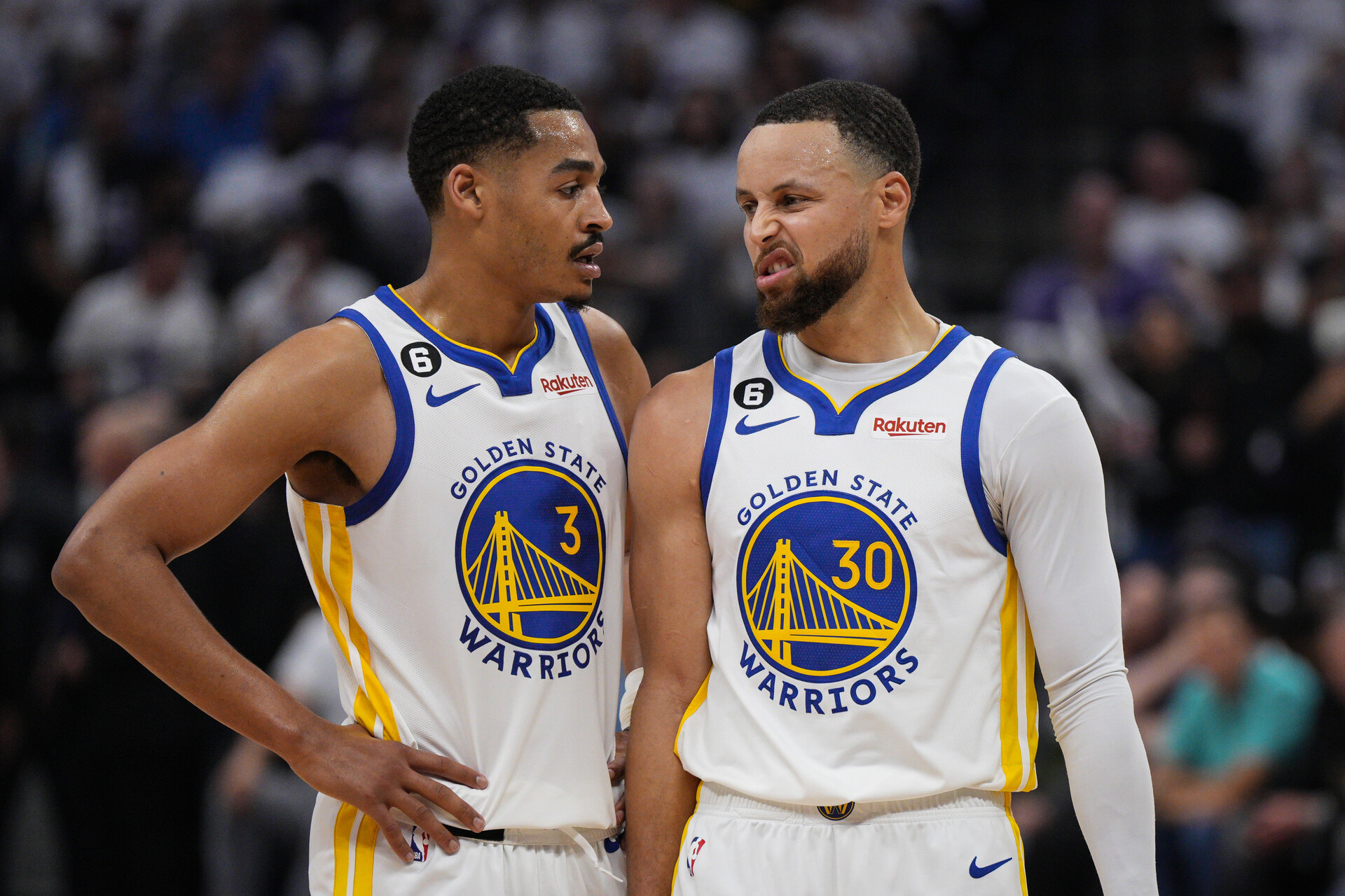 Jordan Poole #3 and Stephen Curry #30 of the Golden State Warriors talk during the second quarter of Game One of the Western Conference First Round Playoffs at the Golden 1 Center on April 15, 2023 in Sacramento, California.