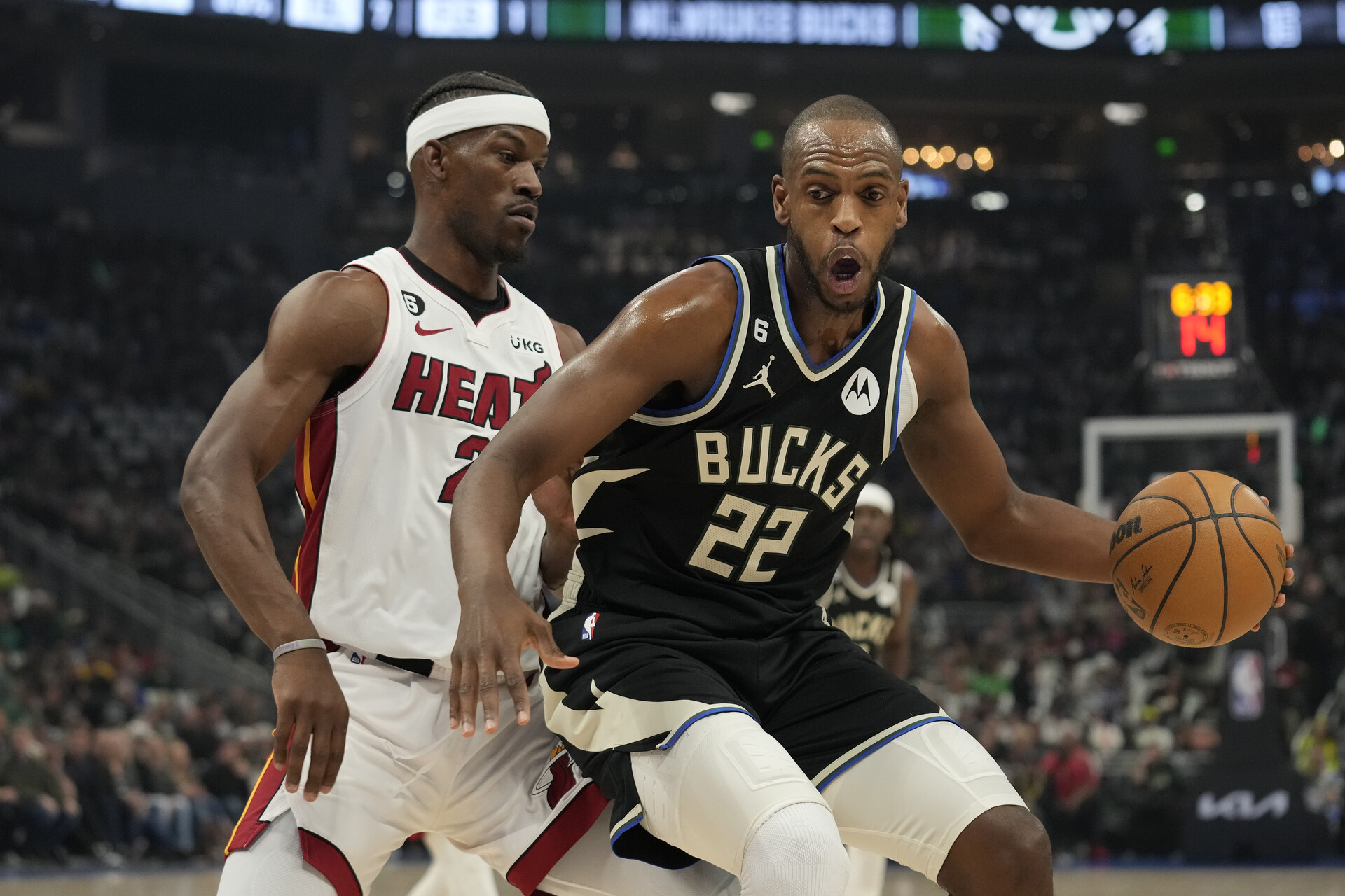 Khris Middleton #22 of the Milwaukee Bucks dribbles the ball against Jimmy Butler #22 of the Miami Heat during the first half of Game Two of the Eastern Conference First Round Playoffs at Fiserv Forum on April 19, 2023 in Milwaukee, Wisconsin.