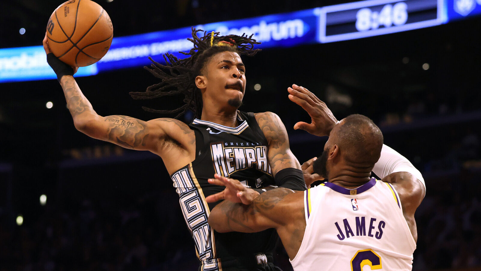 Ja Morant #12 of the Memphis Grizzlies drives to the basket on LeBron James #6 of the Los Angeles Lakers during 111-101 Lakers win in Game Three of the Western Conference First Round Playoffs at Crypto.com Arena on April 22, 2023 in Los Angeles, California.
