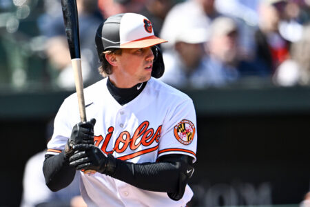 Adley Rutschman #35 of the Baltimore Orioles bats during the first inning against the New York Yankees at Oriole Park at Camden Yards on April 9, 2023 in Baltimore, Maryland.