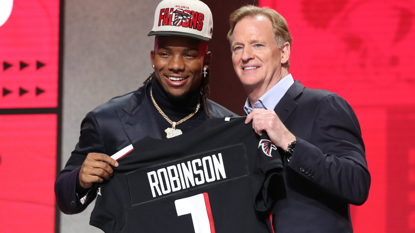 Texas running back Bijan Robinson holds a jersey with commission Roger Goodell after being drafted in the first round of the NFL Draft on April 27, 2023 at Union Station in Kansas City, MO.
