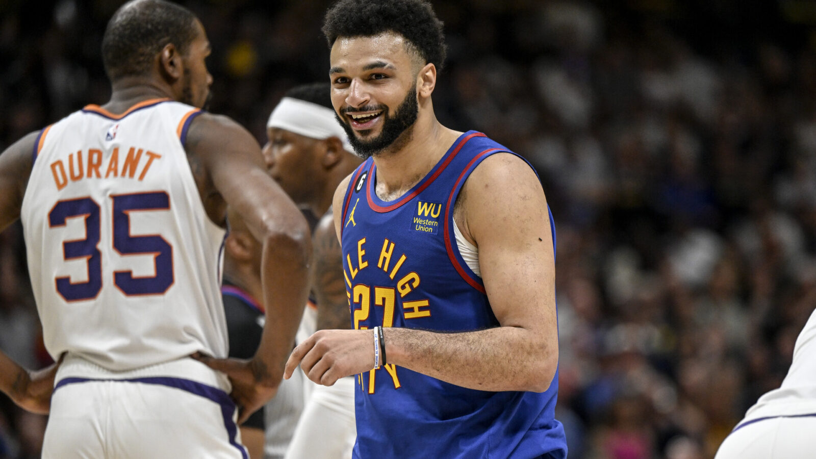 Jamal Murray (27) of the Denver Nuggets smiles after drawing a hard foul from Chris Paul (3) of the Phoenix Suns in transition during the fourth quarter of Denvers 125-107 win at Ball Arena in Denver on Saturday, April 29, 2023. Denver took a 1-0 series lead in the best-of-seven Western Conference semifinal matchup.