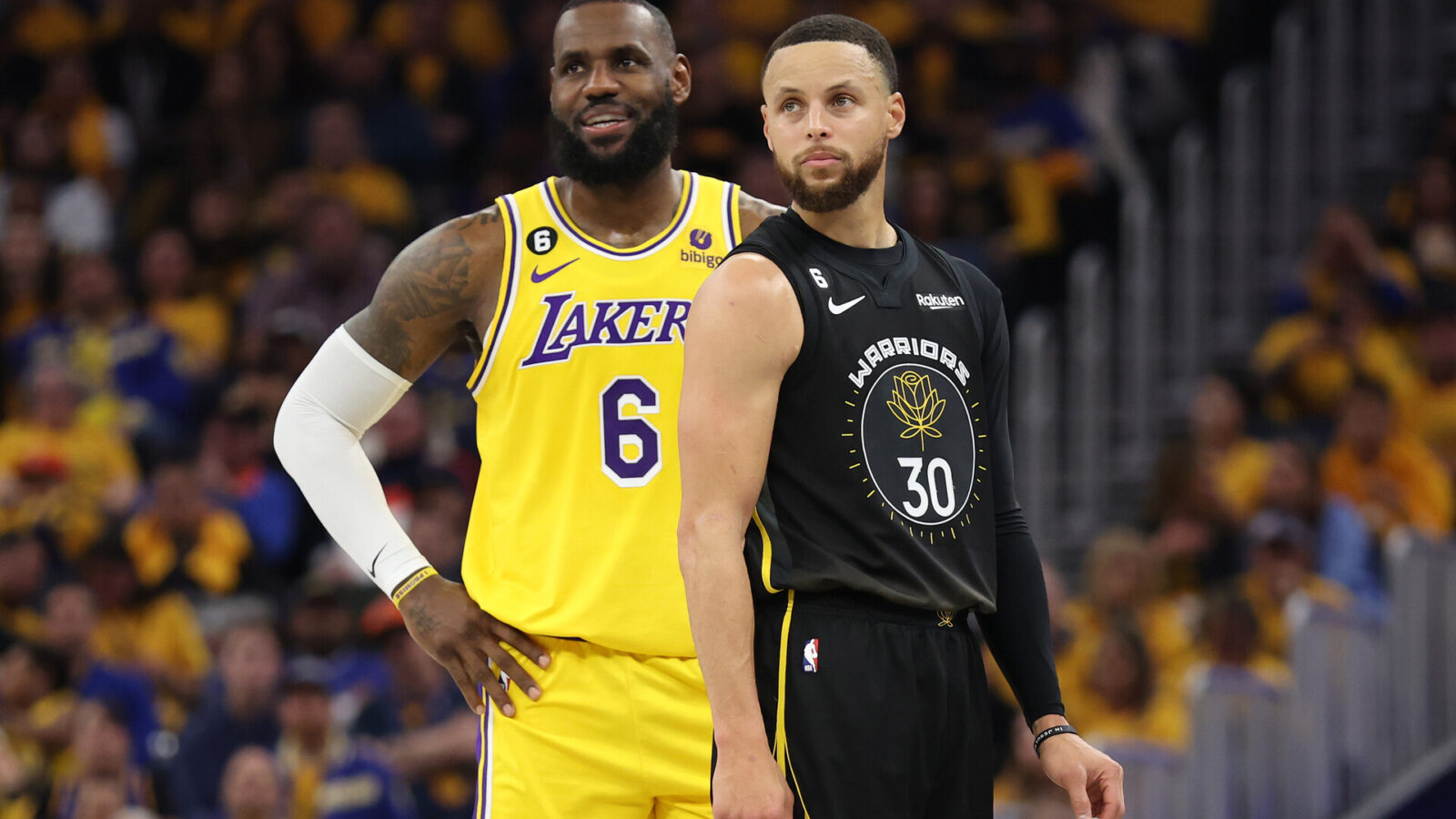 LeBron James #6 of the Los Angeles Lakers stands next to Stephen Curry #30 of the Golden State Warriors during the second quarter in game one of the Western Conference Semifinal Playoffs at Chase Center on May 02, 2023 in San Francisco, California.