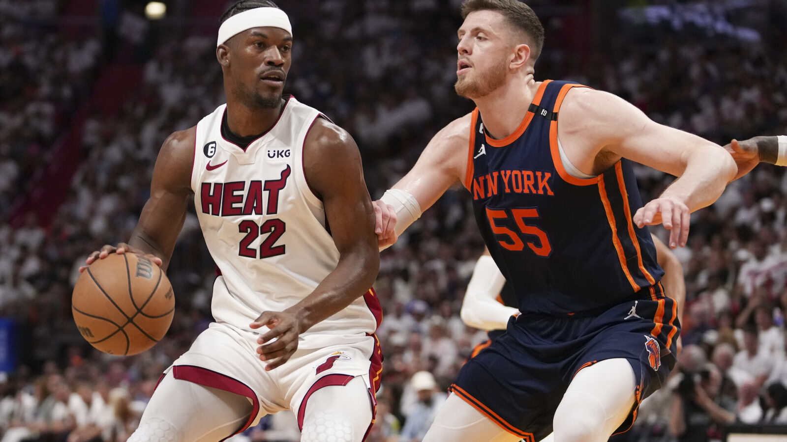 Jimmy Butler #22 of the Miami Heat drives past Isaiah Hartenstein #55 of the New York Knicks during game three of the Eastern Conference Semifinals at Kaseya Center on May 06, 2023 in Miami, Florida.
