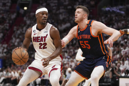 Jimmy Butler #22 of the Miami Heat drives past Isaiah Hartenstein #55 of the New York Knicks during game three of the Eastern Conference Semifinals at Kaseya Center on May 06, 2023 in Miami, Florida.