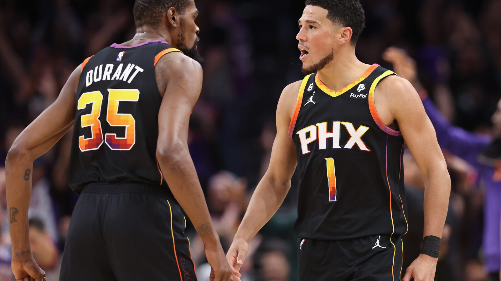 Devin Booker #1 and Kevin Durant #35 of the Phoenix Suns celebrate during Game Three of the NBA Western Conference Semifinals at Footprint Center on May 05, 2023 in Phoenix, Arizona. The Suns defeated the Nuggets 121-114.