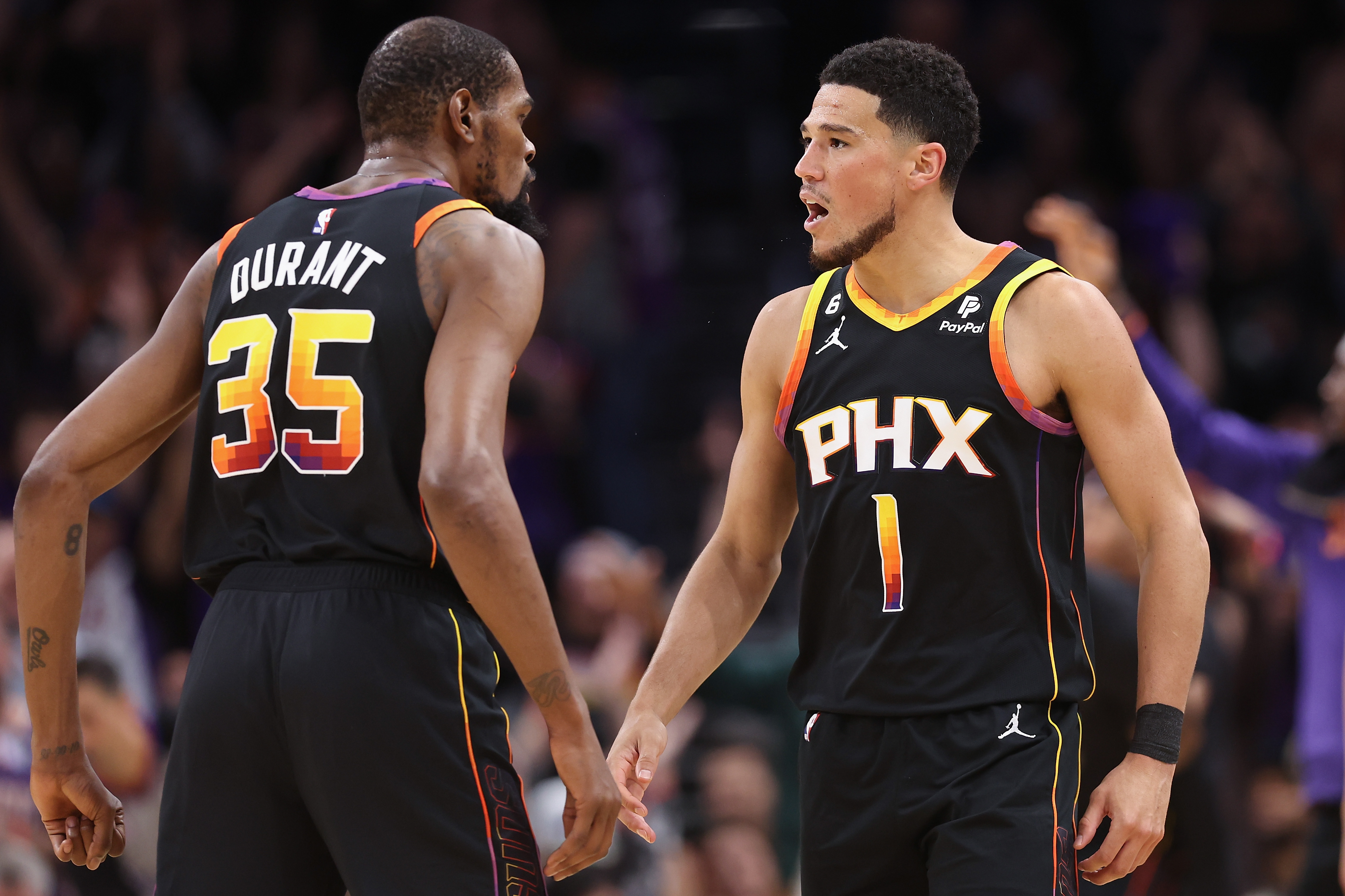 Devin Booker #1 and Kevin Durant #35 of the Phoenix Suns celebrate during Game Three of the NBA Western Conference Semifinals at Footprint Center on May 05, 2023 in Phoenix, Arizona. The Suns defeated the Nuggets 121-114.