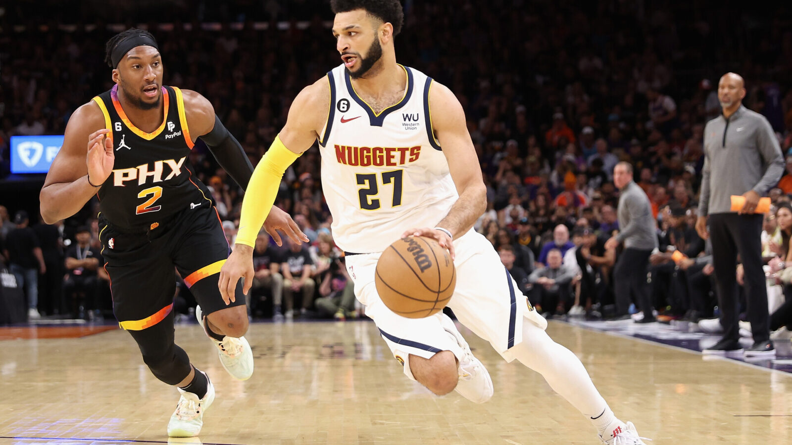 Jamal Murray #27 of the Denver Nuggets drives the ball past Josh Okogie #2 of the Phoenix Suns during Game Four of the NBA Western Conference Semifinals at Footprint Center on May 07, 2023 in Phoenix, Arizona. The Suns defeated the Nuggets 129-124.