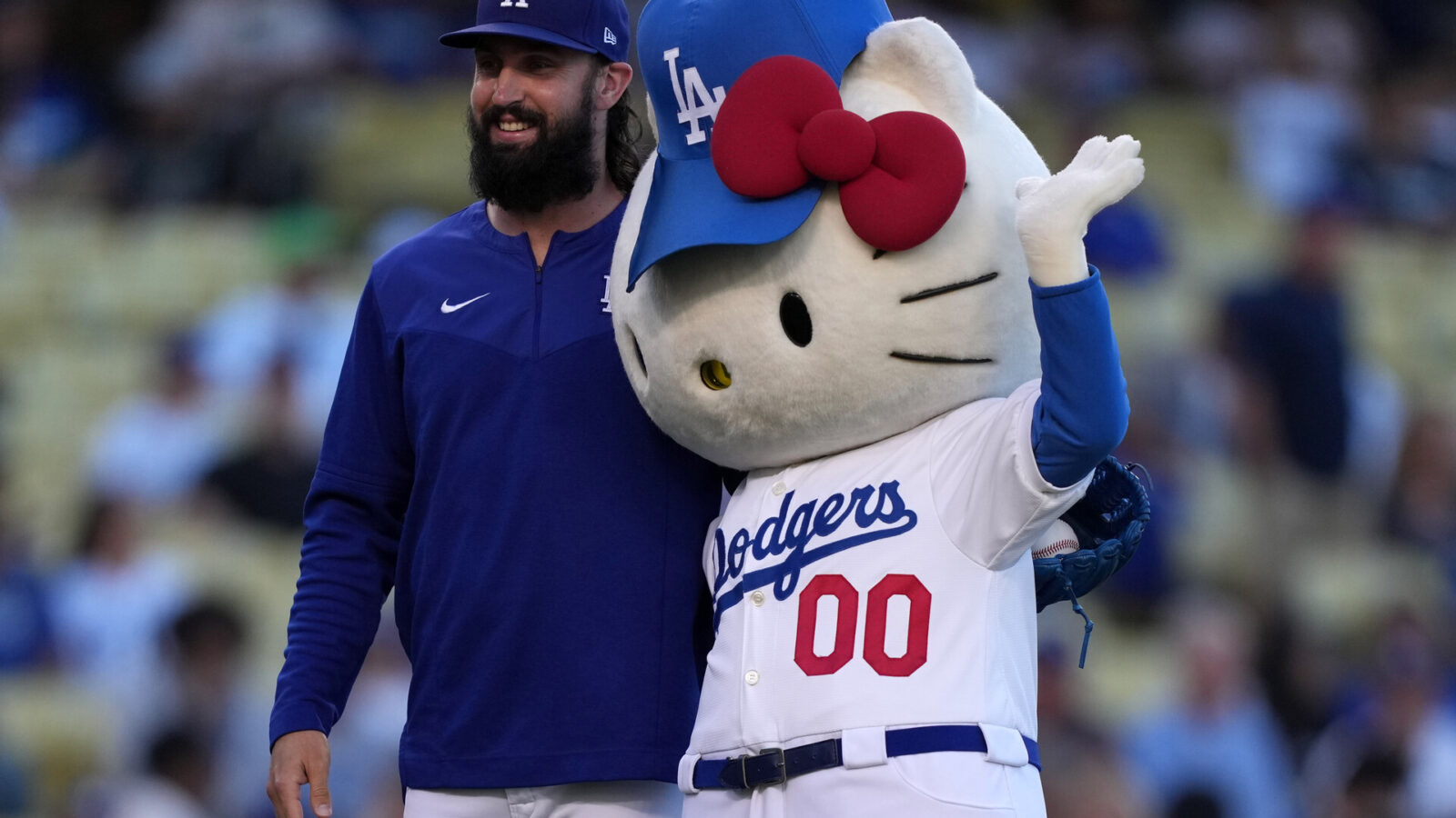 Los Angeles Dodgers pitcher Tony Gonsolin (left) poses with Hello Kitty during the game against the Colorado Rockies at Dodger Stadium.