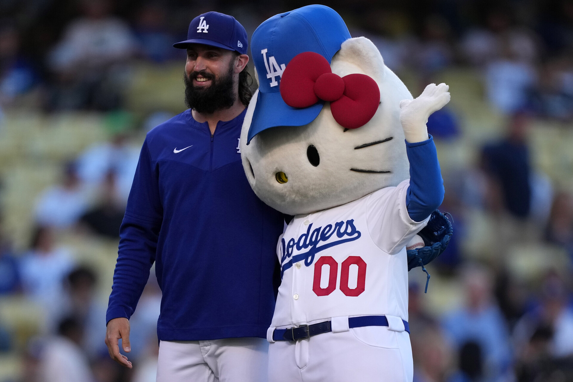 Los Angeles Dodgers pitcher Tony Gonsolin (left) poses with Hello Kitty during the game against the Colorado Rockies at Dodger Stadium.
