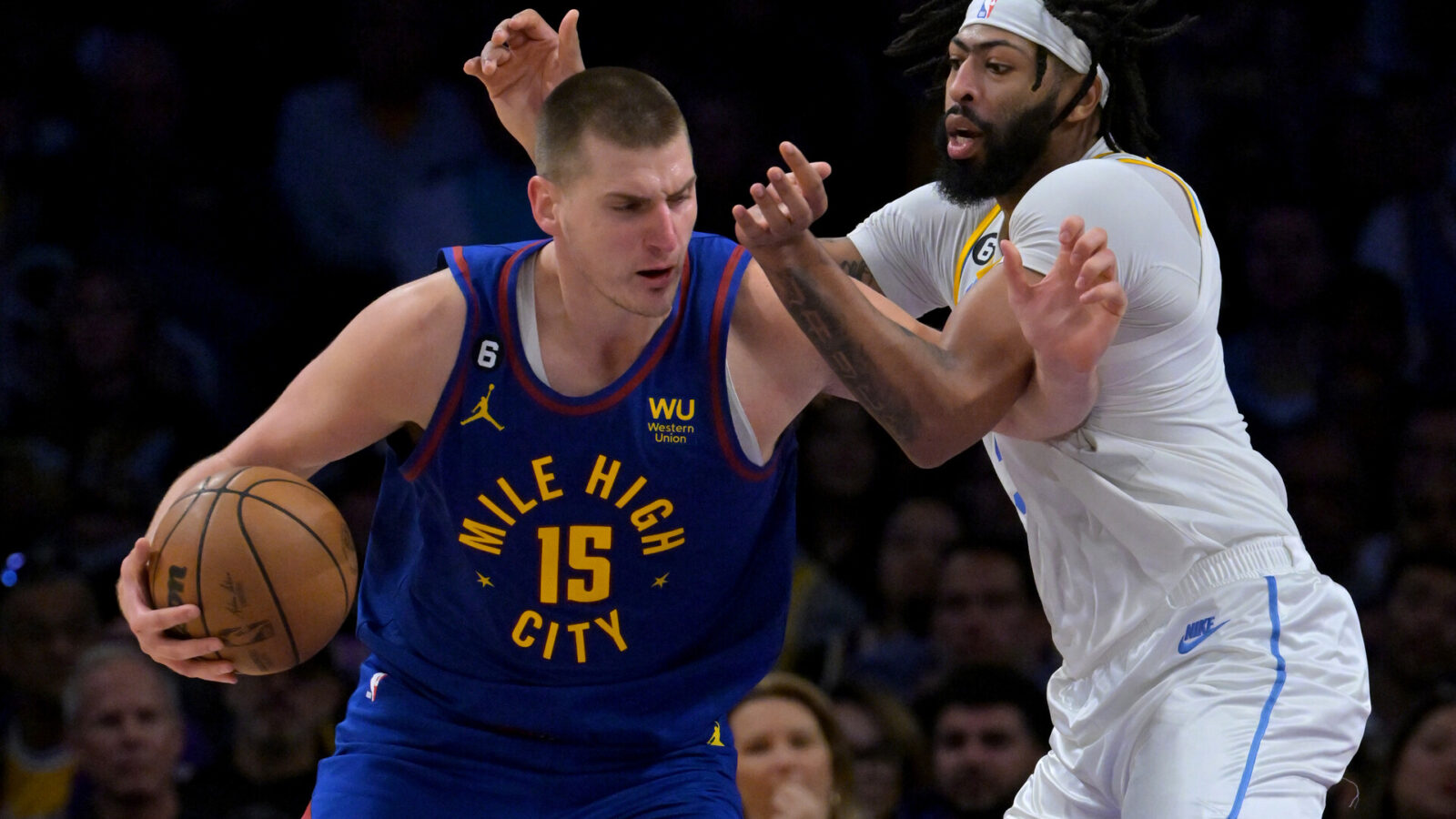 Denver Nuggets center Nikola Jokic (15) is guarded by Los Angeles Lakers forward Anthony Davis (3) in the second half at Crypto.com Arena. Mandatory Credit: