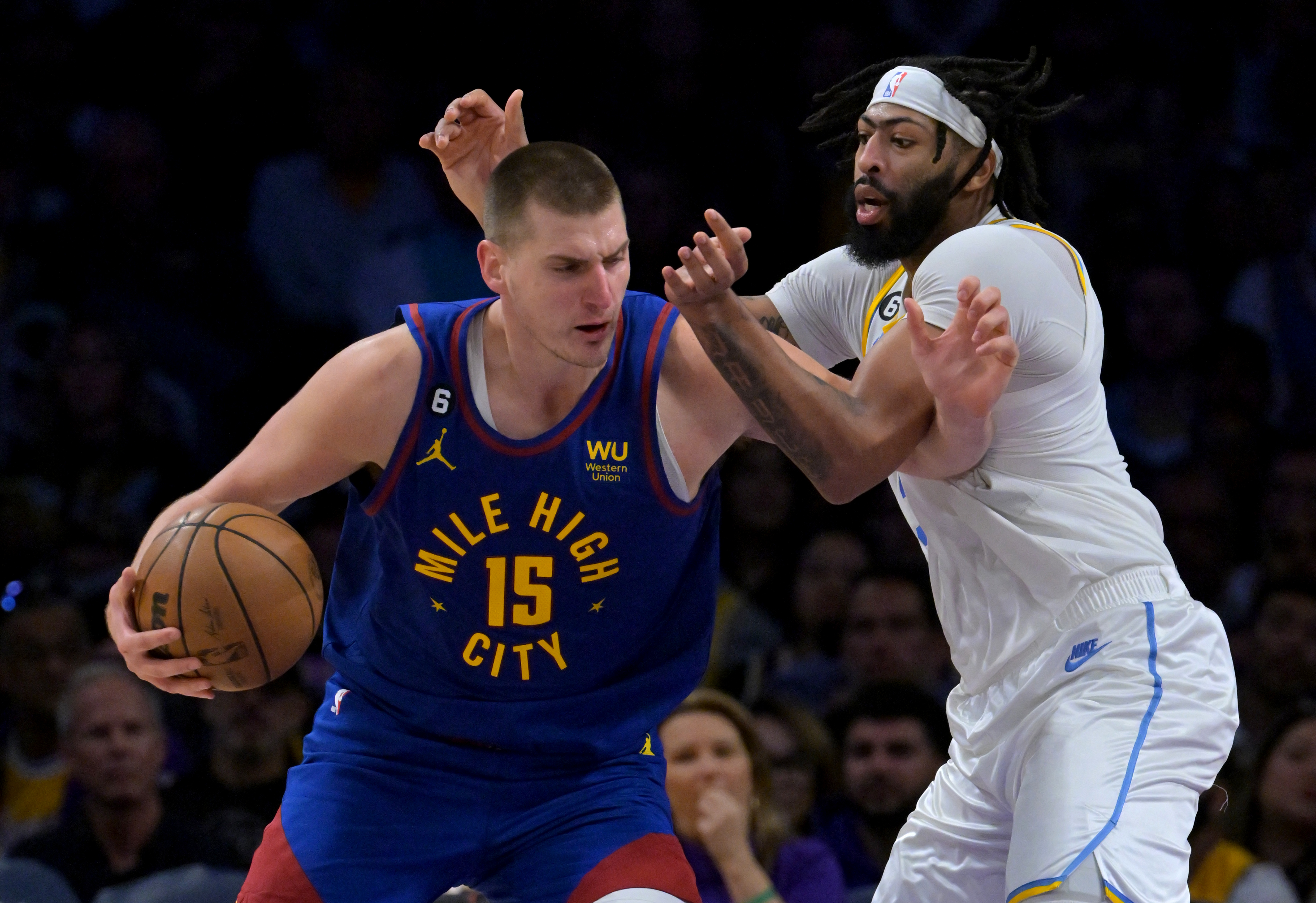 Denver Nuggets center Nikola Jokic (15) is guarded by Los Angeles Lakers forward Anthony Davis (3) in the second half at Crypto.com Arena. Mandatory Credit: