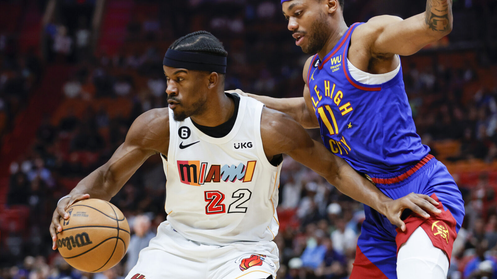 Miami Heat forward Jimmy Butler (22) protects the basketball from Denver Nuggets forward Bruce Brown (11) during the first quarter at Miami-Dade Arena.