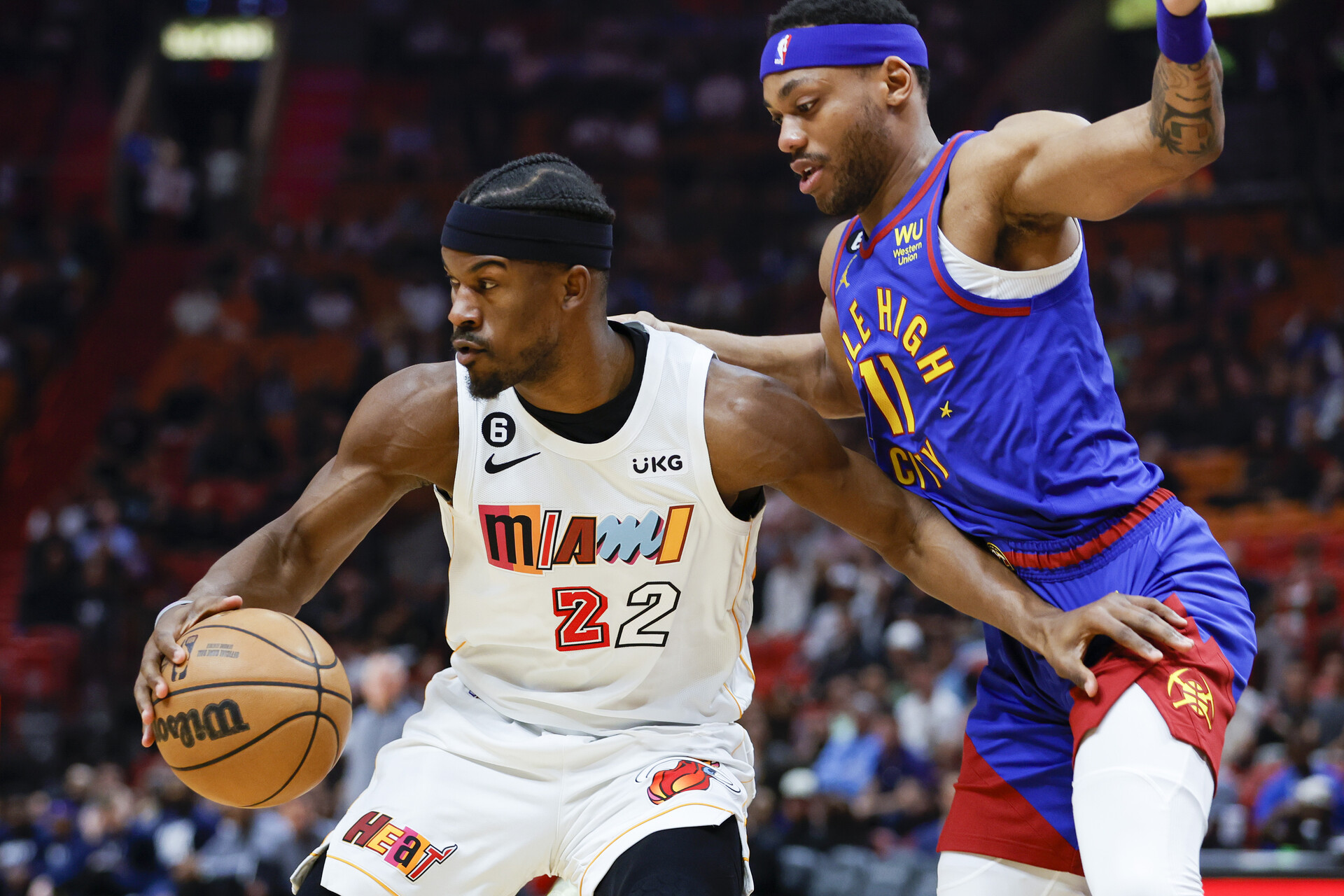 Miami Heat forward Jimmy Butler (22) protects the basketball from Denver Nuggets forward Bruce Brown (11) during the first quarter at Miami-Dade Arena.