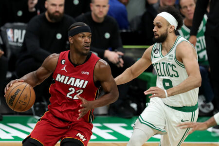 May 17, 2023; Boston, Massachusetts, USA; Miami Heat forward Jimmy Butler (22) dribbles against Boston Celtics guard Derrick White (9) during the second half in game one of the Eastern Conference Finals for the 2023 NBA playoffs at TD Garden.