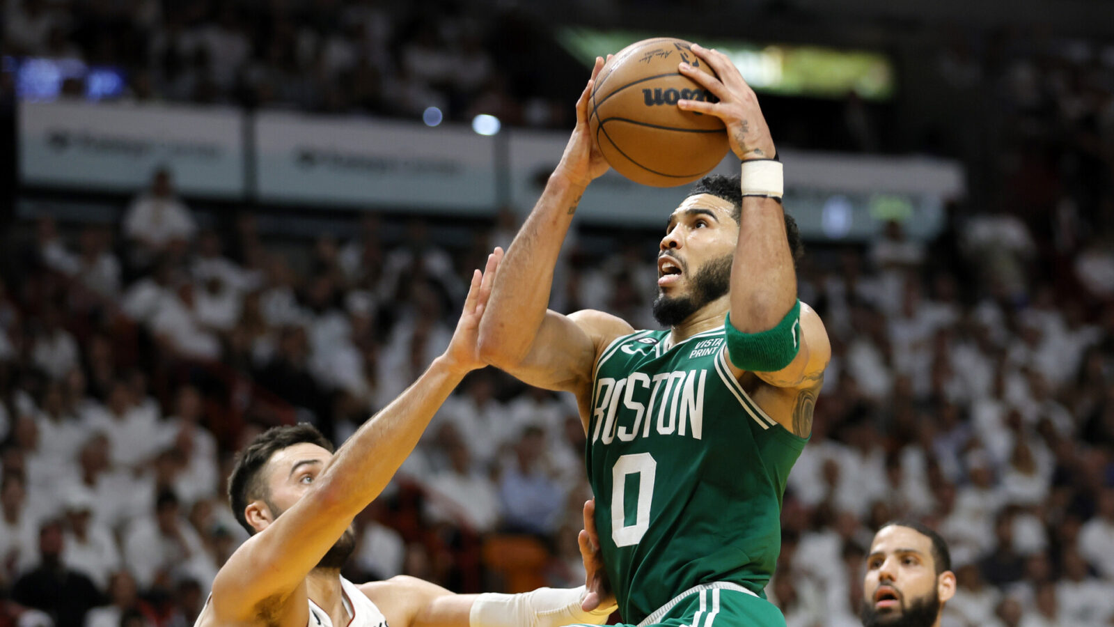 Boston Celtics forward Jayson Tatum (0) shoots against Miami Heat guard Max Strus (31) in the third quarter during game four of the Eastern Conference Finals for the 2023 NBA playoffs at Kaseya Center.