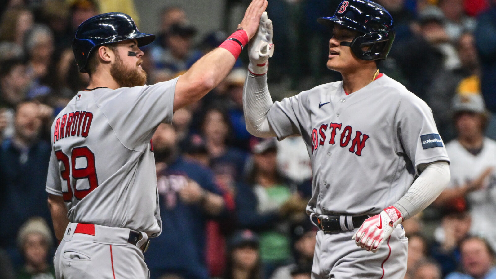 Apr 22, 2023; Milwaukee, Wisconsin, USA; Boston Red Sox shortstop Yu Chang (20) is greeted by second baseman Christian Arroyo (39) after hitting a 2-run homer in the fifth inning against the Milwaukee Brewers at American Family Field.