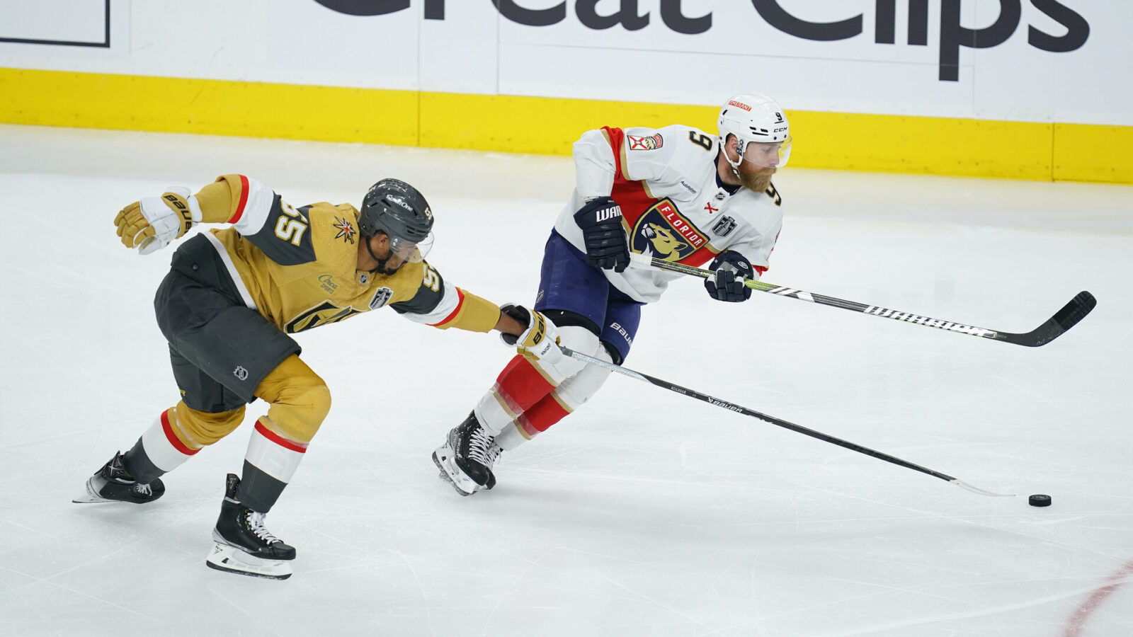 Jun 3, 2023; Las Vegas, Nevada, USA; Vegas Golden Knights right wing Keegan Kolesar (55) reaches for the puck against Florida Panthers center Sam Bennett (9) in game one of the 2023 Stanley Cup Final at T-Mobile Arena.