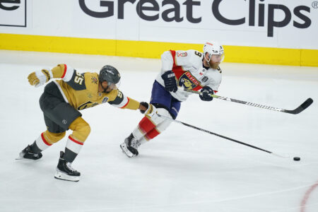 Jun 3, 2023; Las Vegas, Nevada, USA; Vegas Golden Knights right wing Keegan Kolesar (55) reaches for the puck against Florida Panthers center Sam Bennett (9) in game one of the 2023 Stanley Cup Final at T-Mobile Arena.