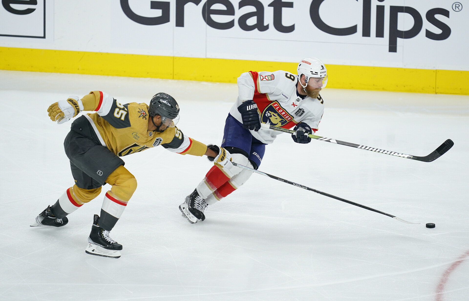 Jun 3, 2023; Las Vegas, Nevada, USA; Vegas Golden Knights right wing Keegan Kolesar (55) reaches for the puck against Florida Panthers center Sam Bennett (9) in game one of the 2023 Stanley Cup Final at T-Mobile Arena.
