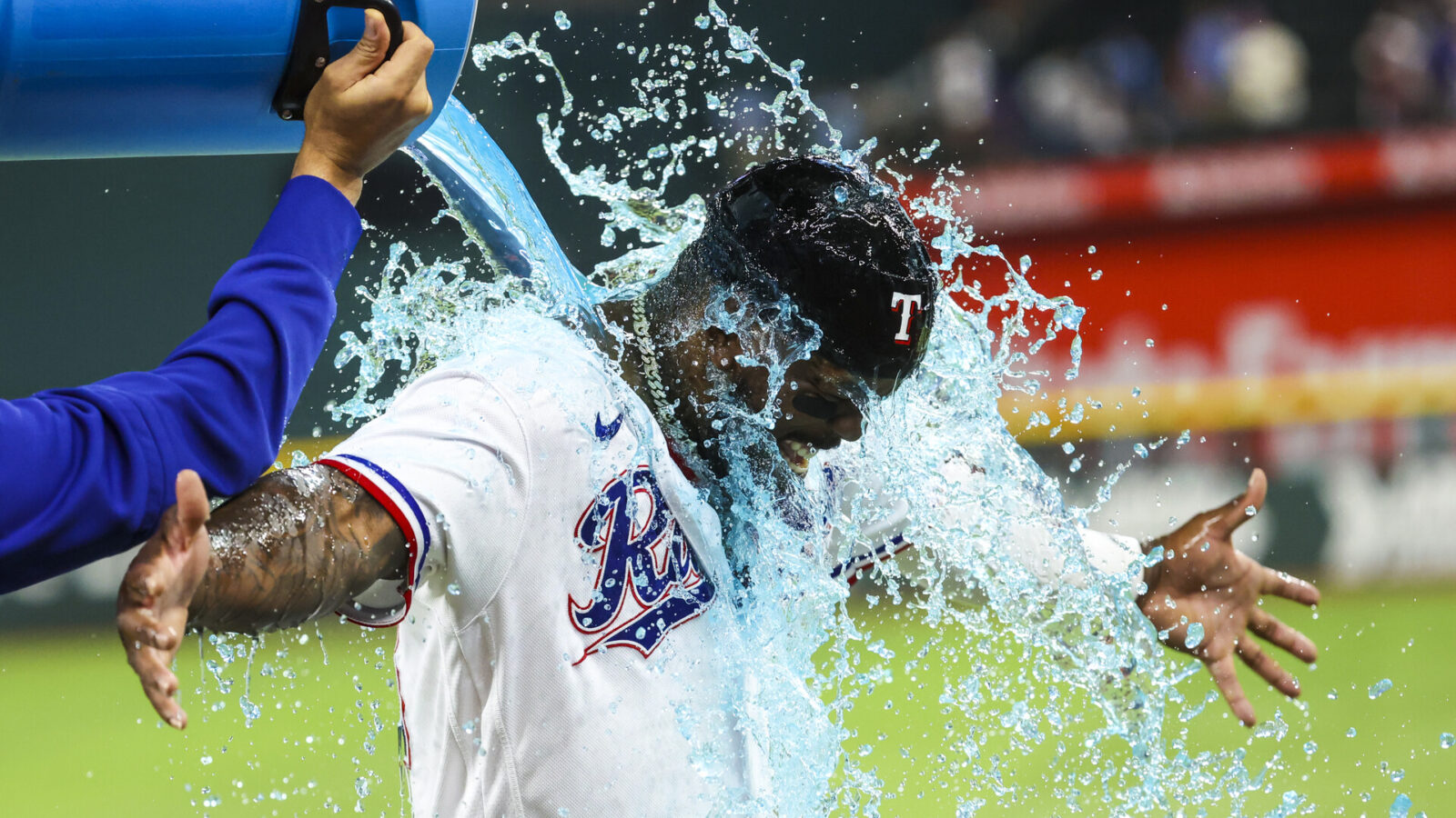 Jun 6, 2023; Arlington, Texas, USA; Texas Rangers starting pitcher Martin Perez (54) gives Texas Rangers right fielder Adolis Garcia (53) a Powerade bath after the game against the St. Louis Cardinals at Globe Life Field.