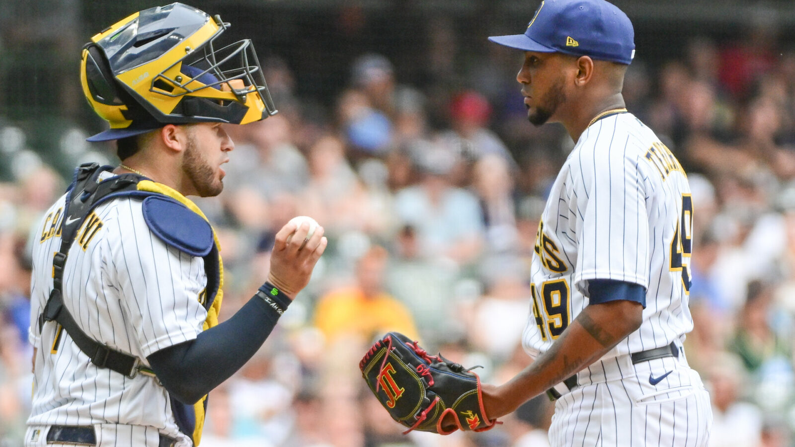 Jun 10, 2023; Milwaukee, Wisconsin, USA; Milwaukee Brewers catcher Victor Caratini (7) talks to pitcher Julio Teheran (49) during a mound visit against the Oakland Athletics at American Family Field.