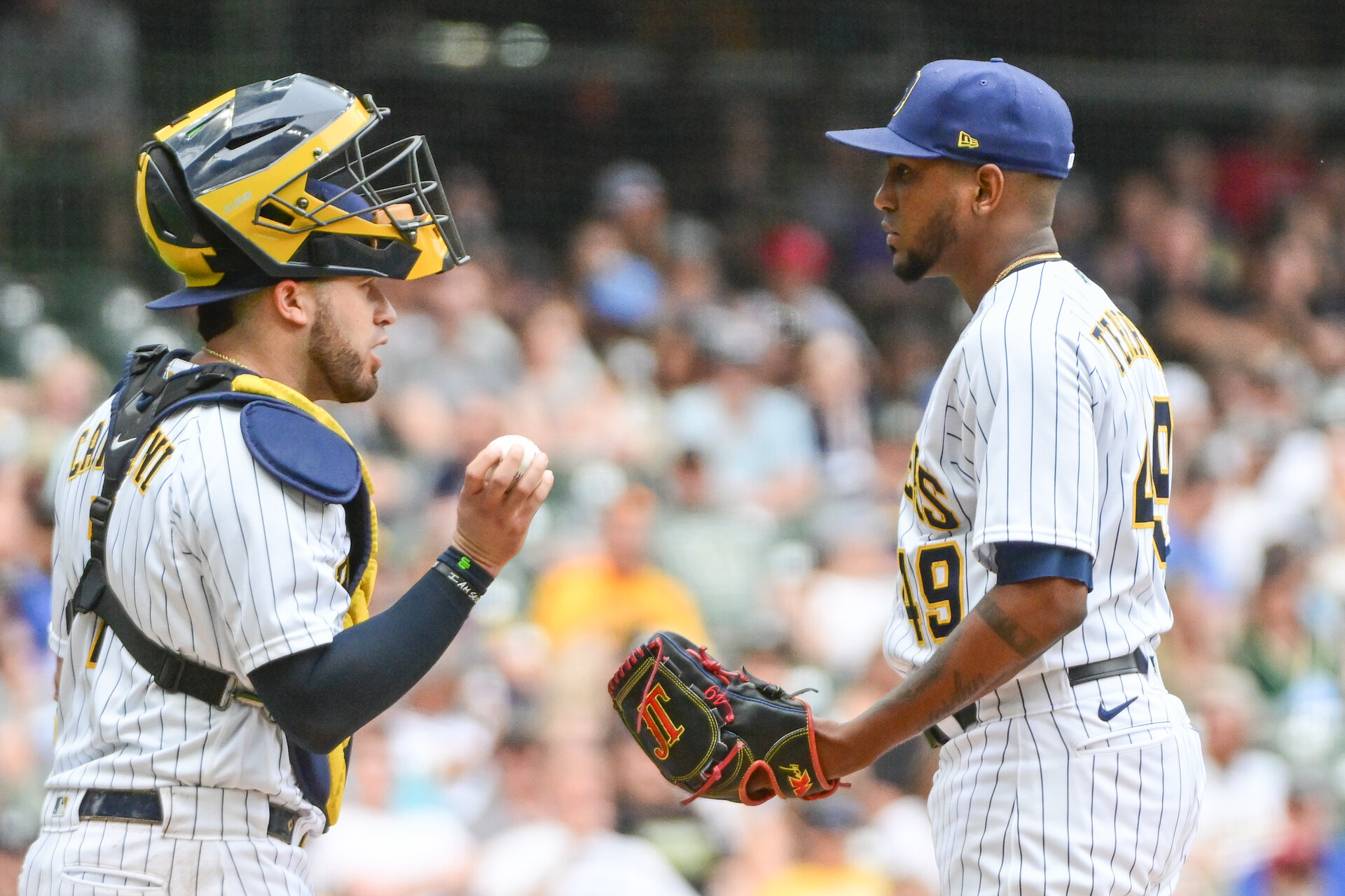 Jun 10, 2023; Milwaukee, Wisconsin, USA; Milwaukee Brewers catcher Victor Caratini (7) talks to pitcher Julio Teheran (49) during a mound visit against the Oakland Athletics at American Family Field.