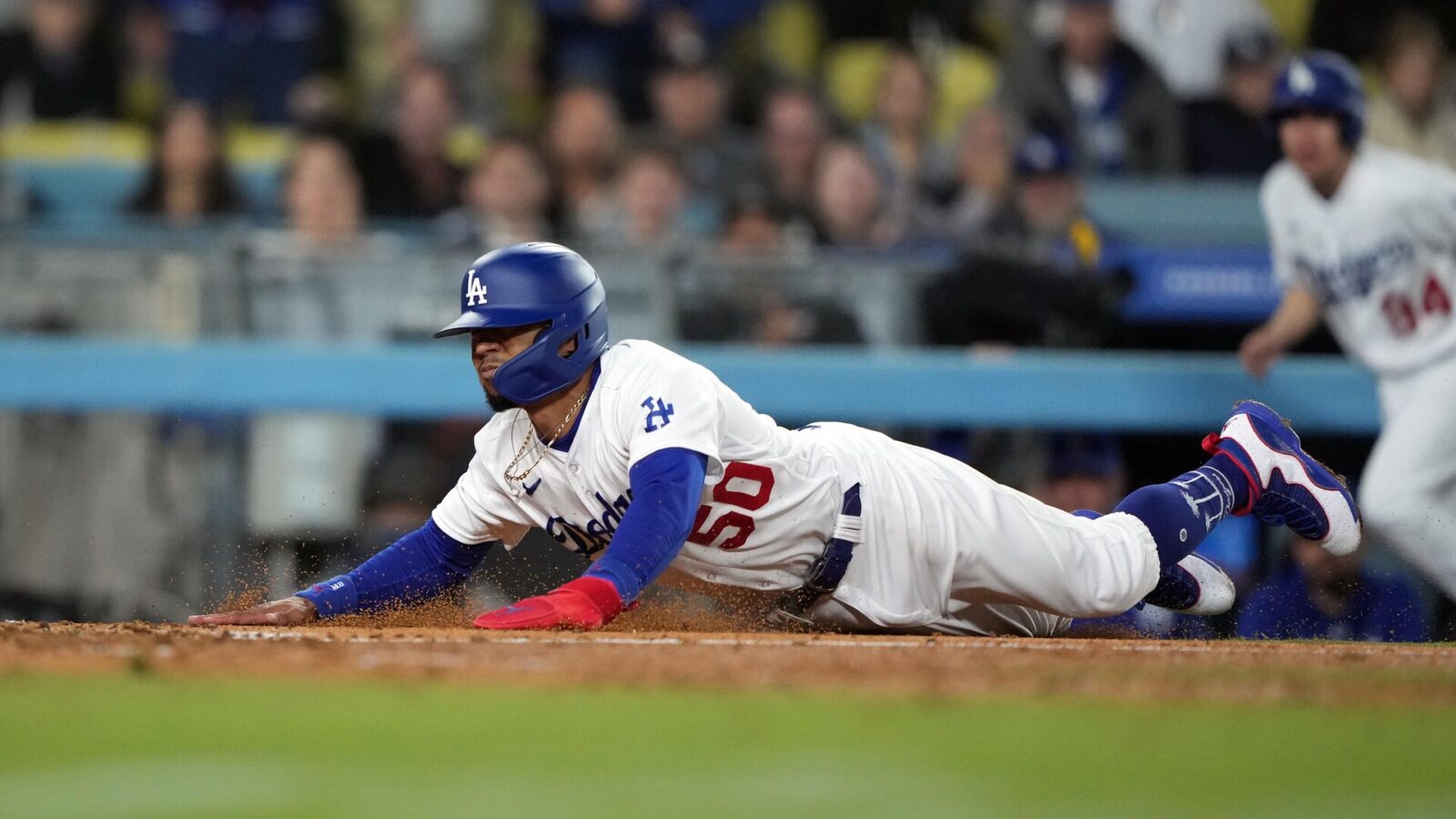 Jun 13, 2023; Los Angeles, California, USA; Los Angeles Dodgers shortstop Mookie Betts (50) slides into home plate in the seventh inning against the Chicago White Sox at Dodger Stadium.