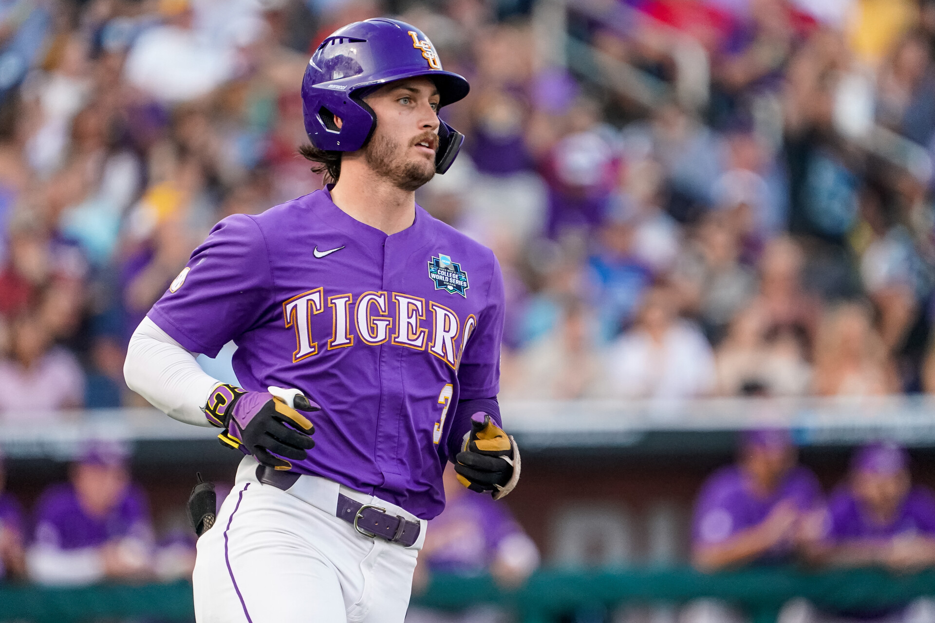LSU Tigers center fielder Dylan Crews (3) runs to first base after hitting a single against the Tennessee Volunteers during the third inning at Charles Schwab Field Omaha.