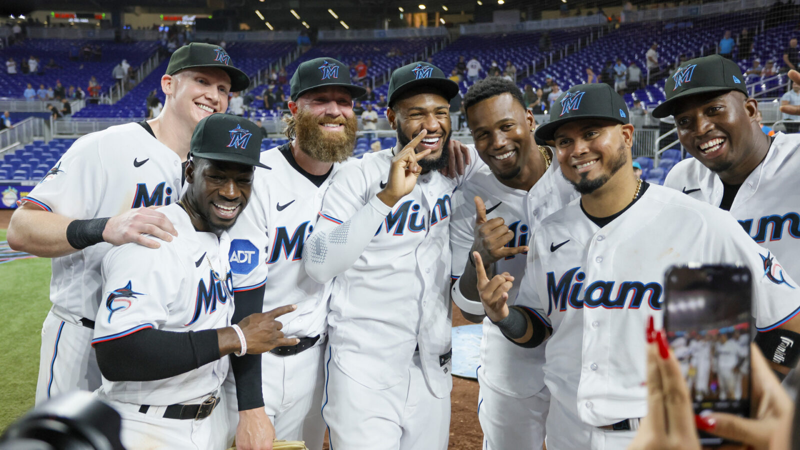 Jun 19, 2023; Miami, Florida, USA; Miami Marlins first baseman Garrett Cooper (26), center fielder Jonathan Davis (49), starting pitcher Braxton Garrett (29), left fielder Bryan De La Cruz (14), designated hitter Jorge Soler (12) and right fielder Jesus Sanchez (7) celebrate with second baseman Luis Arraez (3) after his five-hit game against the Toronto Blue Jays at loanDepot Park.