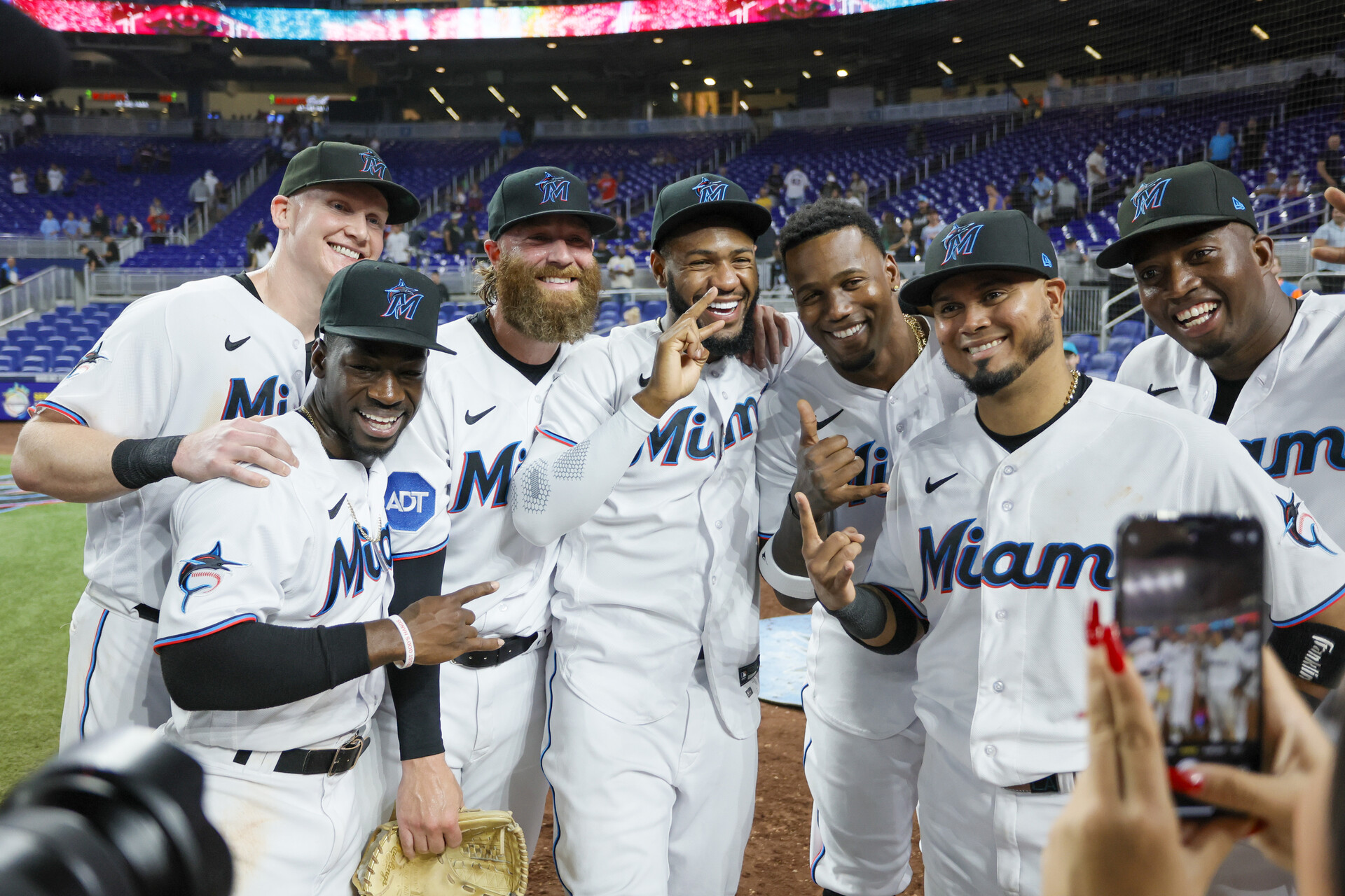 Jun 19, 2023; Miami, Florida, USA; Miami Marlins first baseman Garrett Cooper (26), center fielder Jonathan Davis (49), starting pitcher Braxton Garrett (29), left fielder Bryan De La Cruz (14), designated hitter Jorge Soler (12) and right fielder Jesus Sanchez (7) celebrate with second baseman Luis Arraez (3) after his five-hit game against the Toronto Blue Jays at loanDepot Park.