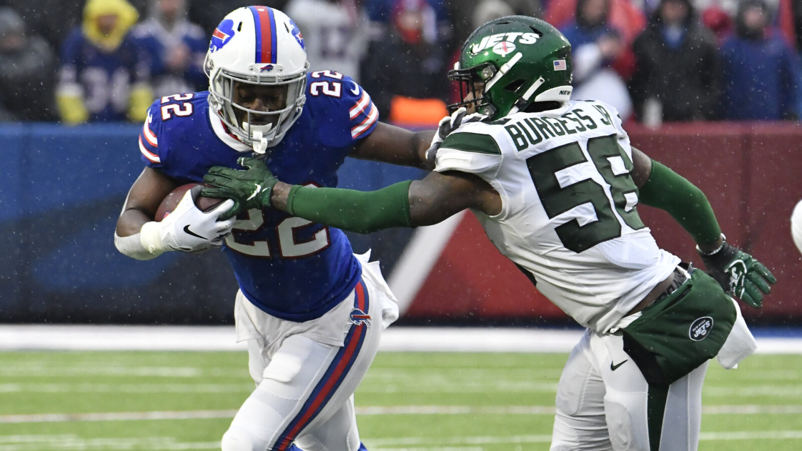 Buffalo Bills running back T.J. Yeldon (22) tries to outrun New York Jets outside linebacker James Burgess (58) in the third quarter at New Era Field.