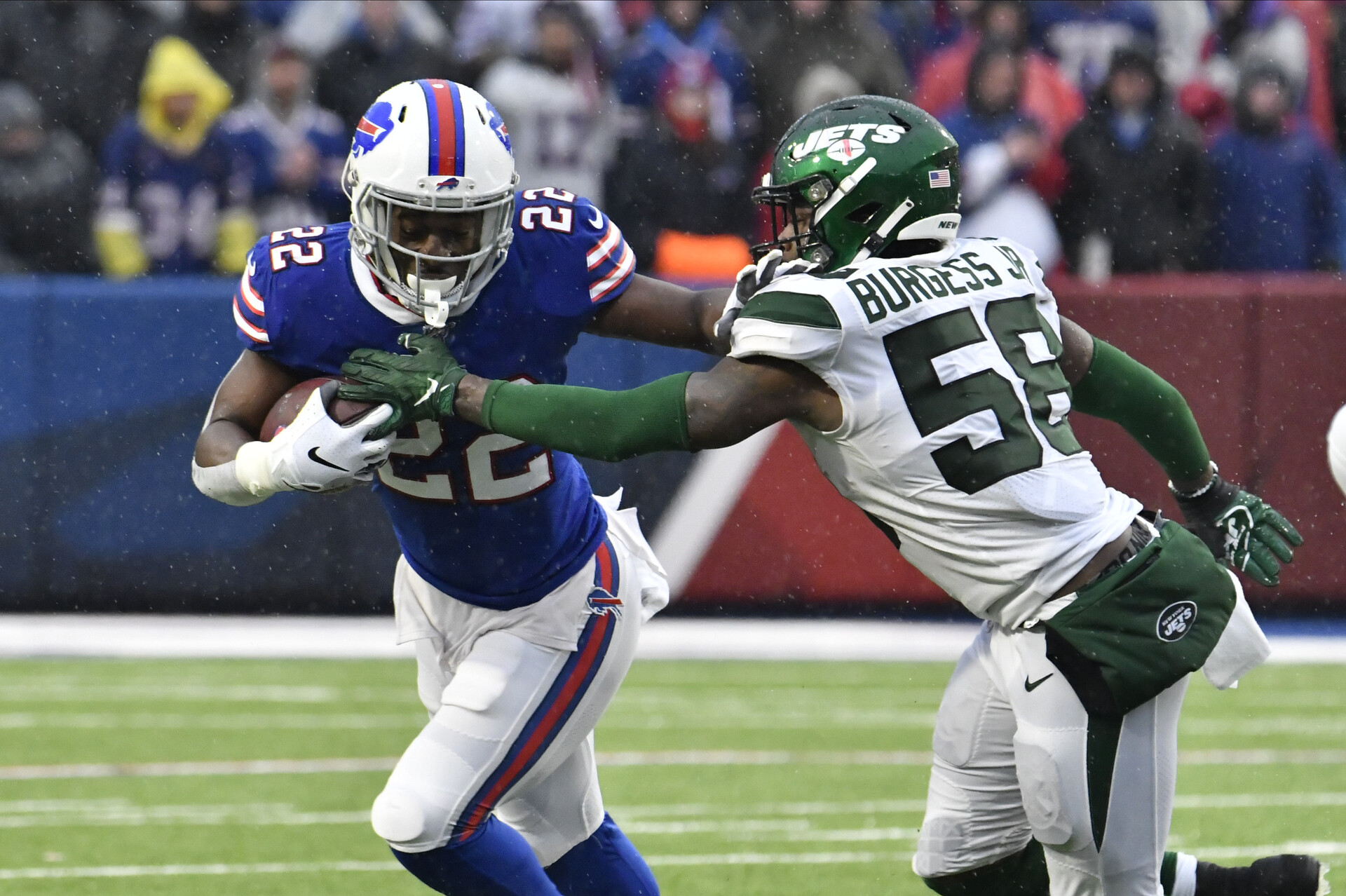 Buffalo Bills running back T.J. Yeldon (22) tries to outrun New York Jets outside linebacker James Burgess (58) in the third quarter at New Era Field.