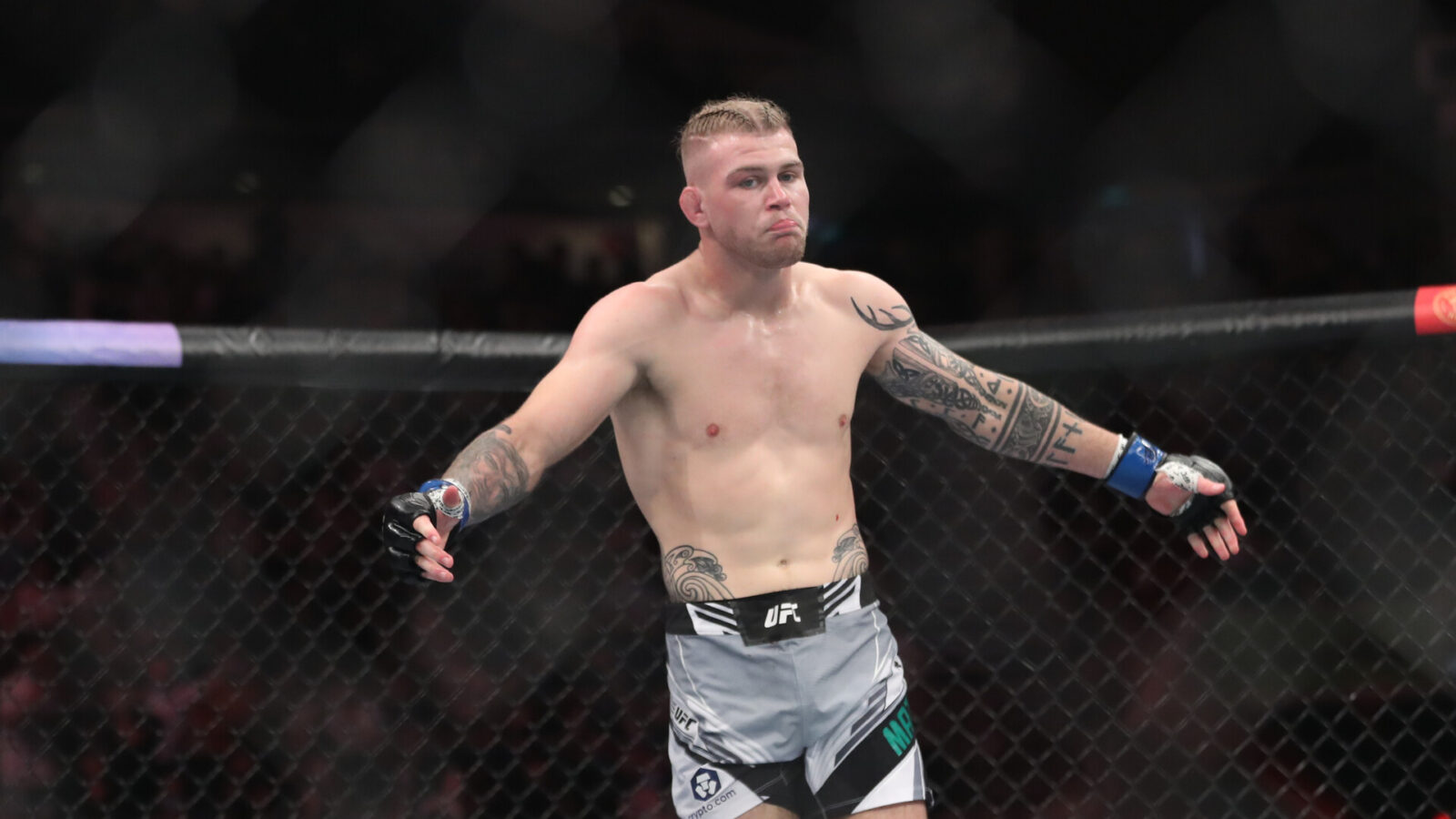 Jakes Matthews (blue gloves) reacts after the fight against Andre Fialho (red gloves) during UFC 275 at Singapore Indoor Stadium.