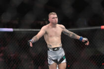 Jakes Matthews (blue gloves) reacts after the fight against Andre Fialho (red gloves) during UFC 275 at Singapore Indoor Stadium.