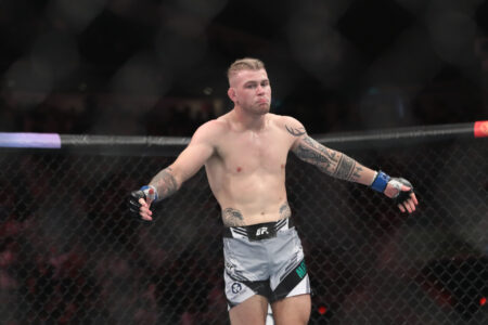 Jakes Matthews (blue gloves) reacts after the fight against Andre Fialho (red gloves) during UFC 275 at Singapore Indoor Stadium.
