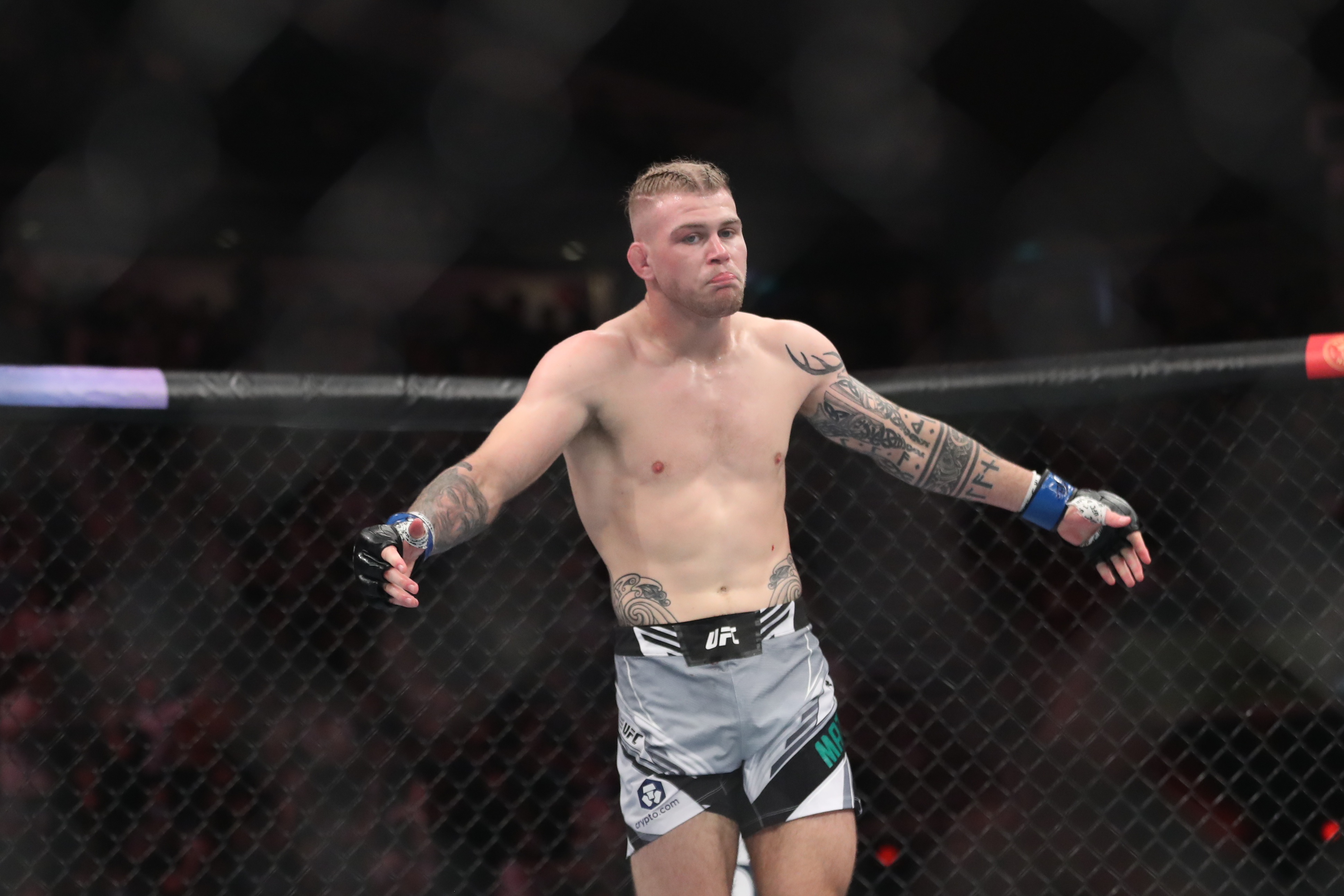 Jakes Matthews (blue gloves) reacts after the fight against Andre Fialho (red gloves) during UFC 275 at Singapore Indoor Stadium.