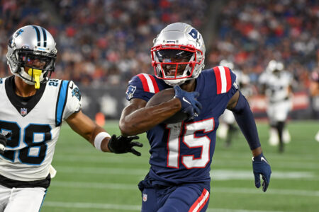 New England Patriots wide receiver Nelson Agholor (15) runs after making a catch with Carolina Panthers cornerback Keith Taylor Jr. (28) in pursuit during the first half of a preseason game at Gillette Stadium.