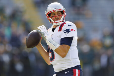 New England Patriots quarterback Brian Hoyer (5) throws a pass during warmups prior to the game against the Green Bay Packers at Lambeau Field.