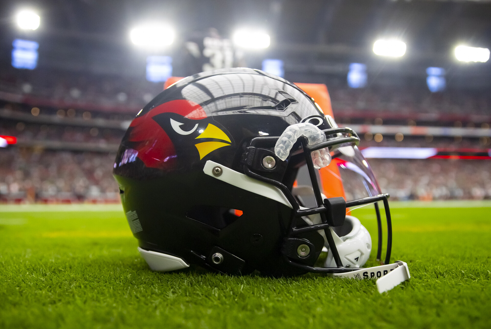 Oct 9, 2022; Glendale, Arizona, USA; Detailed view of a black Arizona Cardinals helmet on the field at State Farm Stadium.