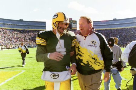 Green Bay Packers quarterback Brett Favre (4) and Green Bay Packers head coach Mike Holmgren walk off the field together after the victory of the Detroit Lions on Oct. 15, 1995 at Lambeau Field in Green Bay, Wis.