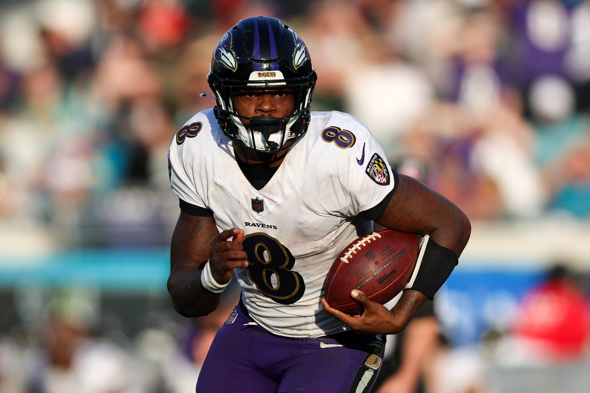 Nov 27, 2022; Jacksonville, Florida, USA; Baltimore Ravens quarterback Lamar Jackson (8) runs with the ball against the Jacksonville Jaguars in the fourth quarter at TIAA Bank Field.