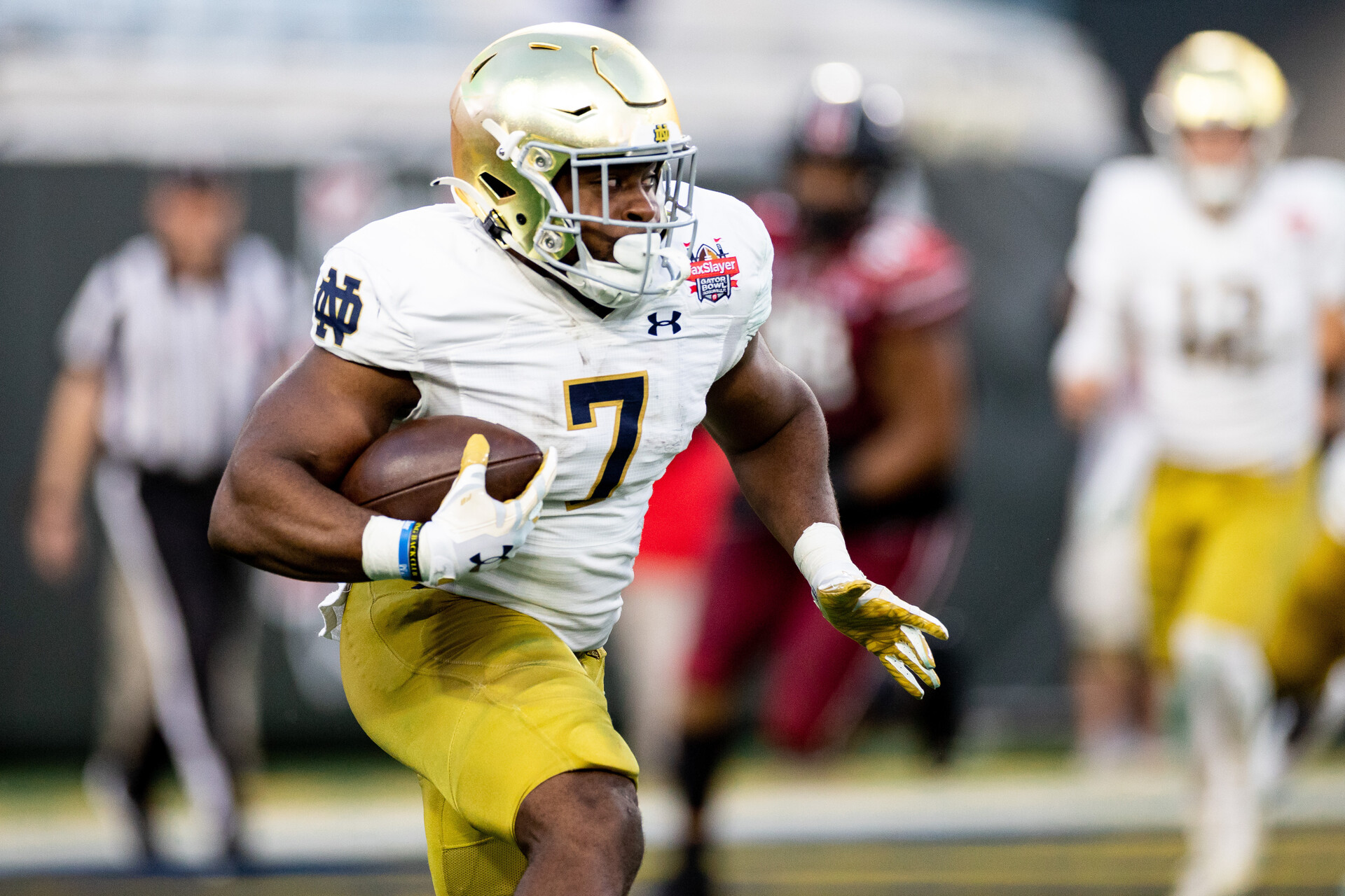 Dec 30, 2022; Jacksonville, FL, USA; Notre Dame Fighting Irish running back Audric Estime (7) runs with the ball during the first half against the South Carolina Gamecocks in the 2022 Gator Bowl at TIAA Bank Field.