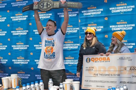 World Champion Competitive Eater Joey Chestnut reacts to winning the World Burrito Eating Contest with Qdoba representatives at the Beer Garden in Deer District in Milwaukee on Thursday, April 6, 2023. The event, hosted by Qdoba, coinciding with National Burrito Day, included Chestnut and other contestants competing to consume as many Qdoba burritos as possible during a 10-minute window for prize money.