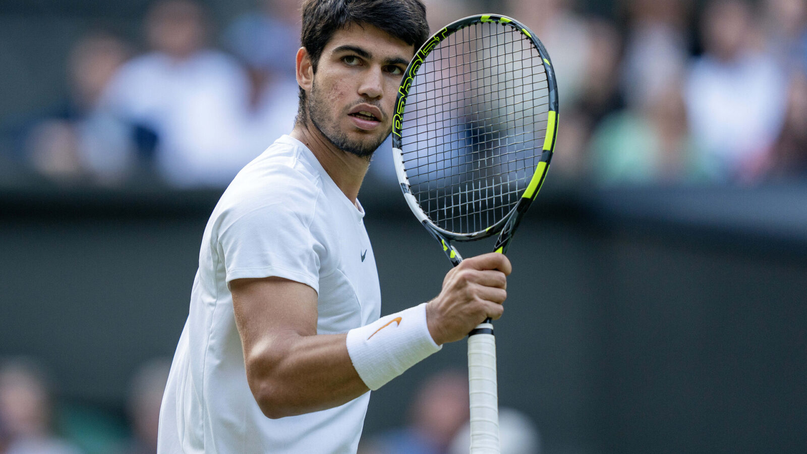 Jul 12, 2023; London, United Kingdom; Carlos Alcaraz (ESP) reacts to a point during his match against Holger Rune (DEN) on day ten of Wimbledon at the All England Lawn Tennis and Croquet Club.